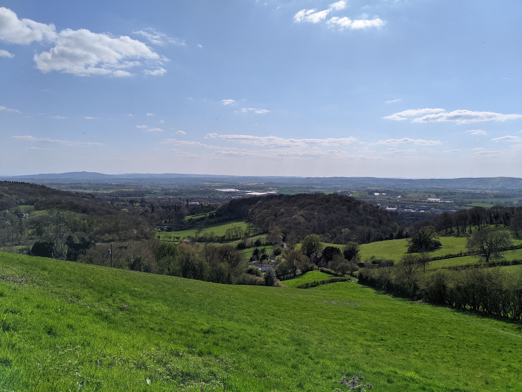 A view of rolling Herefordshire countryside on a sunny day.